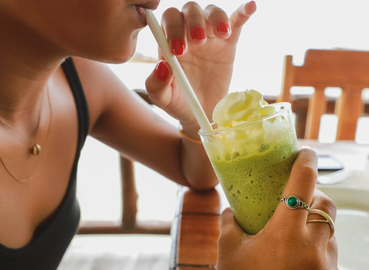 close-up woman sipping smoothie with straw, daily habits prematurely aging your skin