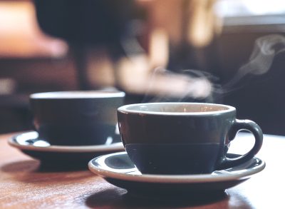 two blue cups filled with hot coffee