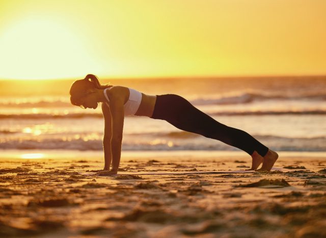 woman doing beach pushups as part of 30-day workout