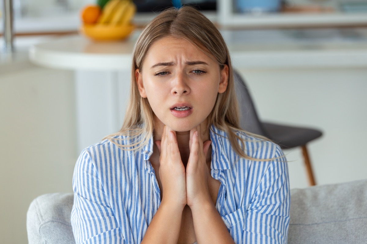 Close,Up,Of,Young,Woman,Rubbing,Her,Inflamed,Tonsils,,Tonsilitis