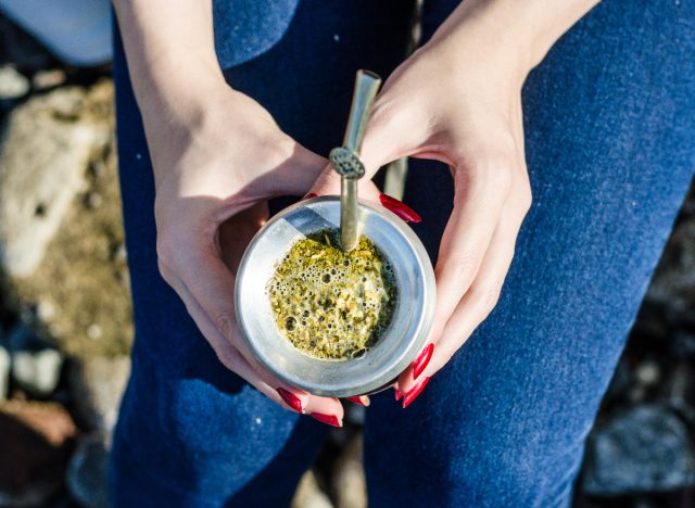 woman holding yerba mate