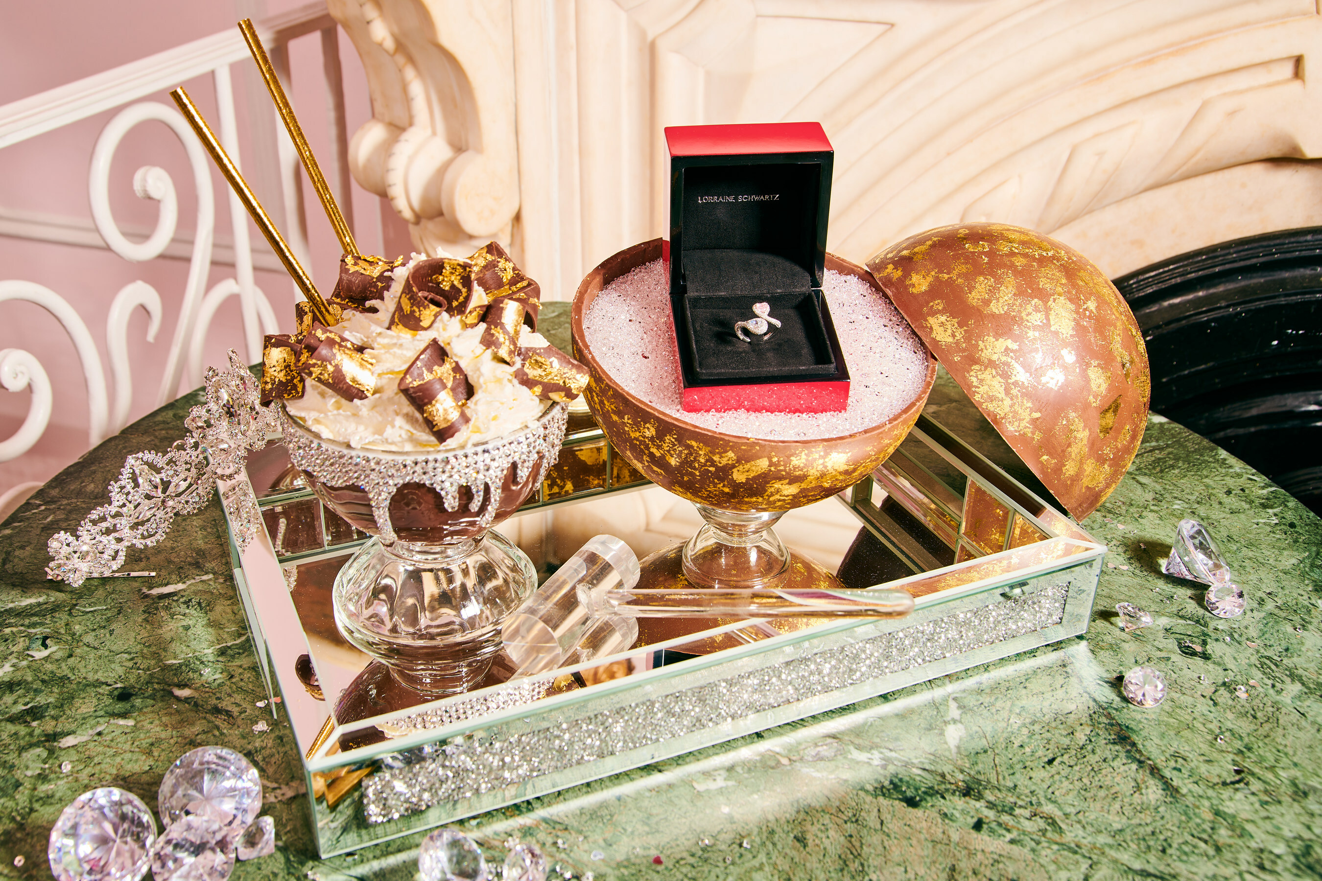 frozen hot chocolate goblet alongside a chocolate sphere containing a diamond ring