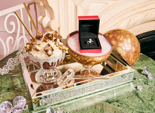 frozen hot chocolate goblet alongside a chocolate sphere containing a diamond ring