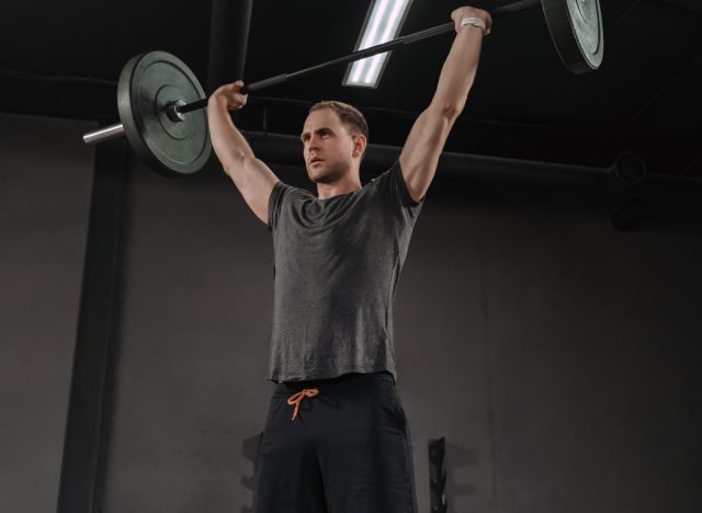 man performing barbell overhead press exercise