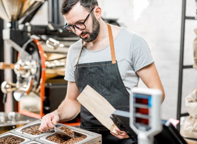 employee filling bag with coffee beans