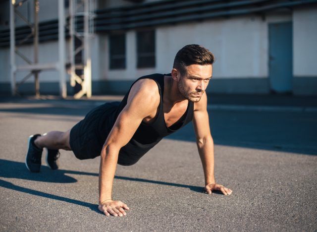 fit man in high plank, getting ready to perform pushups