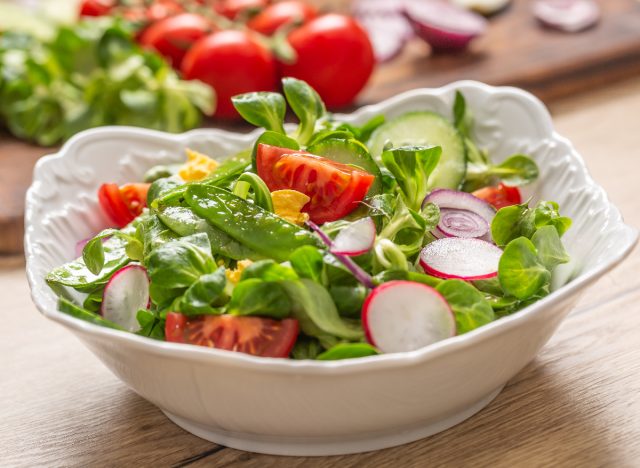 fresh green salad in white bowl