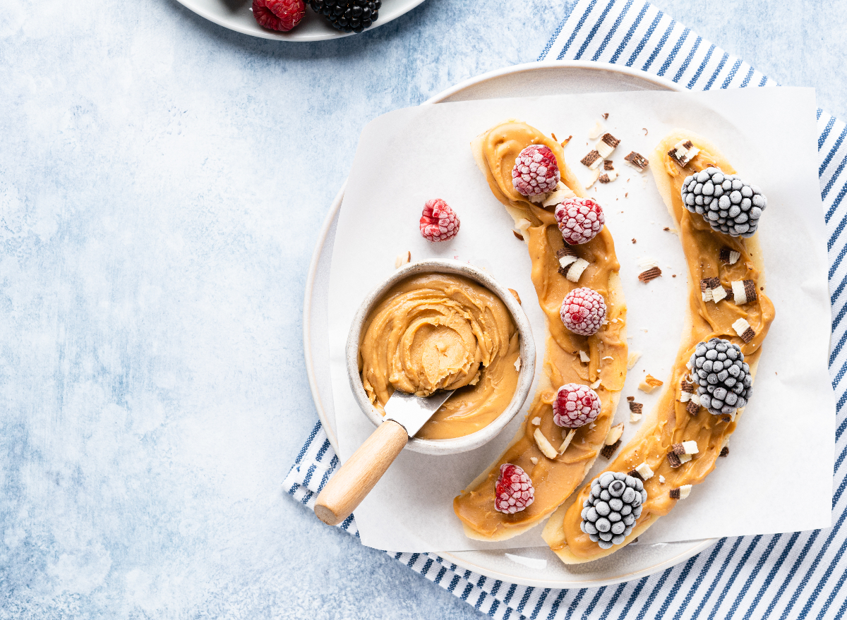 bananas and frozen fruit with peanut butter on plate, concept of morning habits to lose weight faster