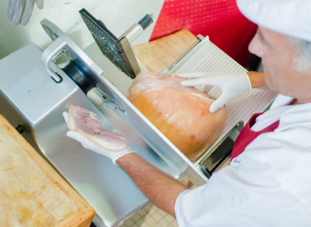 hand slicing deli meat