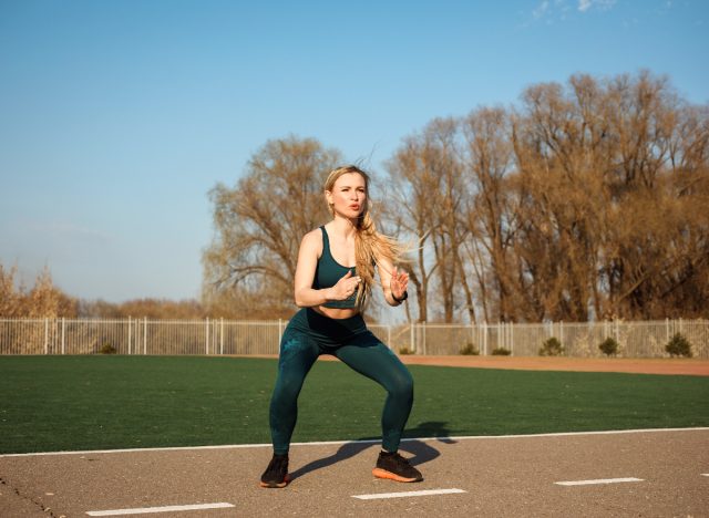 woman doing jump squats, part of workout to drop 10 pounds fast