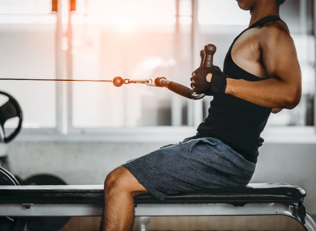 fitness man doing cable pulley row