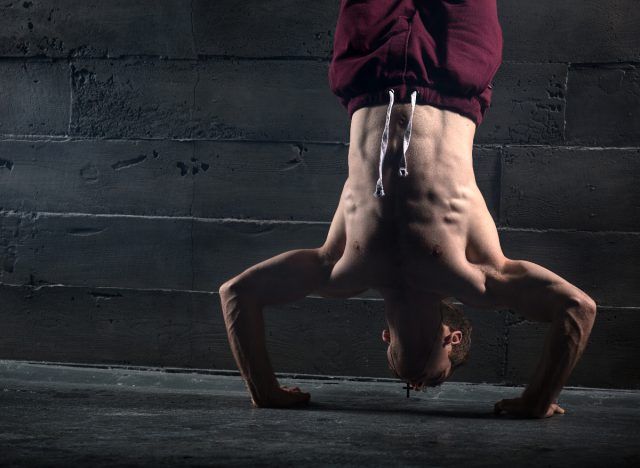muscular man handstand, exercises for men to build muscle