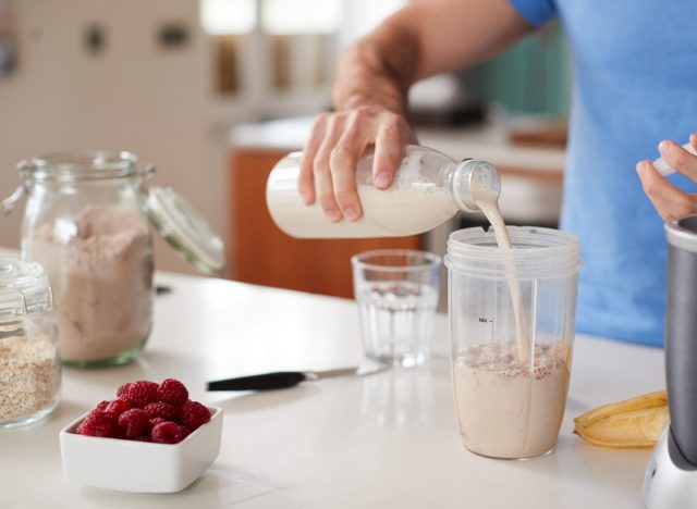 man making post-workout protein shake