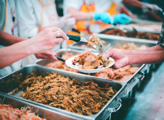 man serving brisket