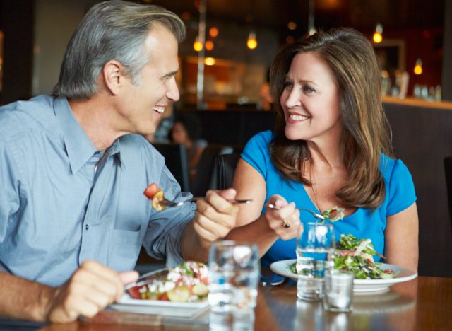 mature couple eating lunch or dinner out at restaurant