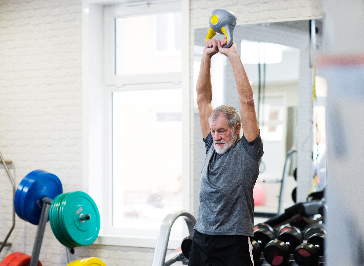 mature man working out with kettlebell, demonstrating what a daily strength training habit does to your body after 50
