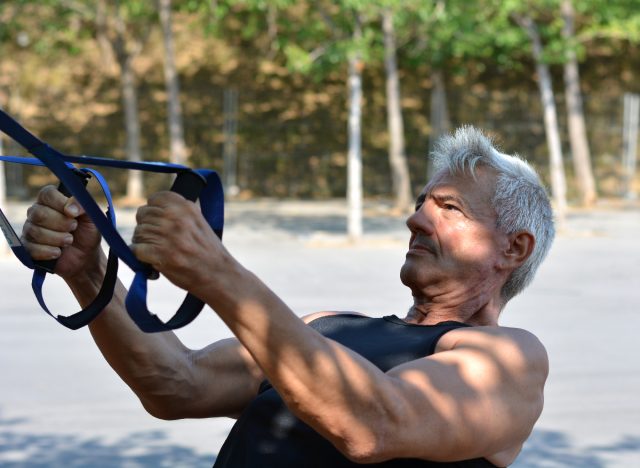 mature man muscle-building TRX exercise