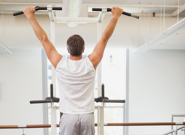 mature man doing pull-ups for stronger muscles after 40