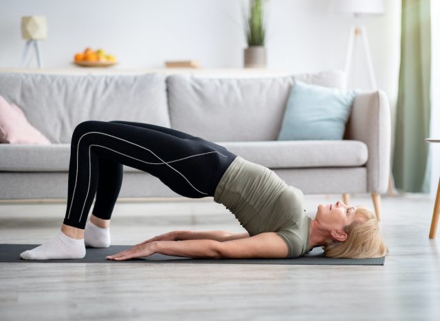 mature woman doing bridge exercise at home