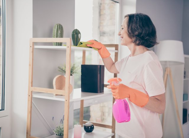 mature woman cleaning her bright house