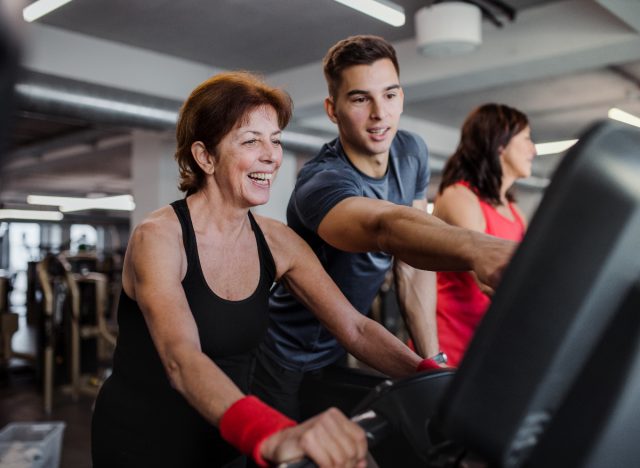 mature woman working with a personal trainer