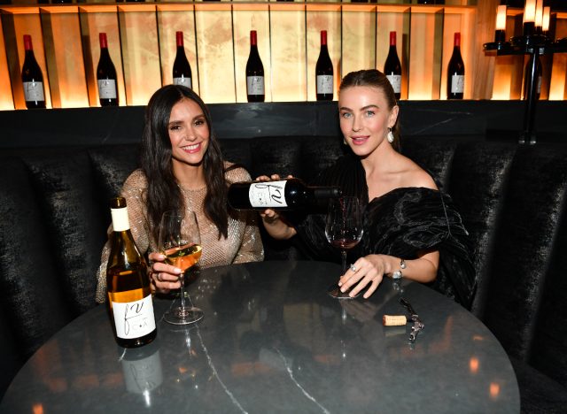 nina dobrev and julianne hough holding fresh vine wine at launch party