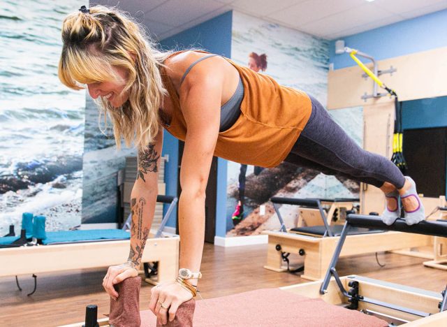 woman doing plank on Pilates reformer
