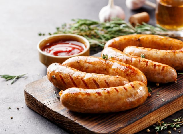 sausage links on cutting board, worst foods to lose visceral fat