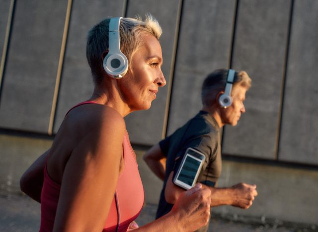 senior couple running, performing outdoor cardio to feel younger