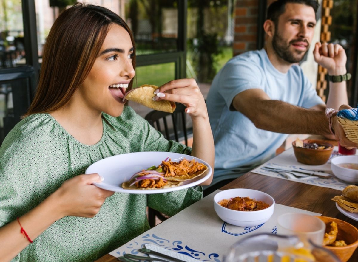 woman eating taco