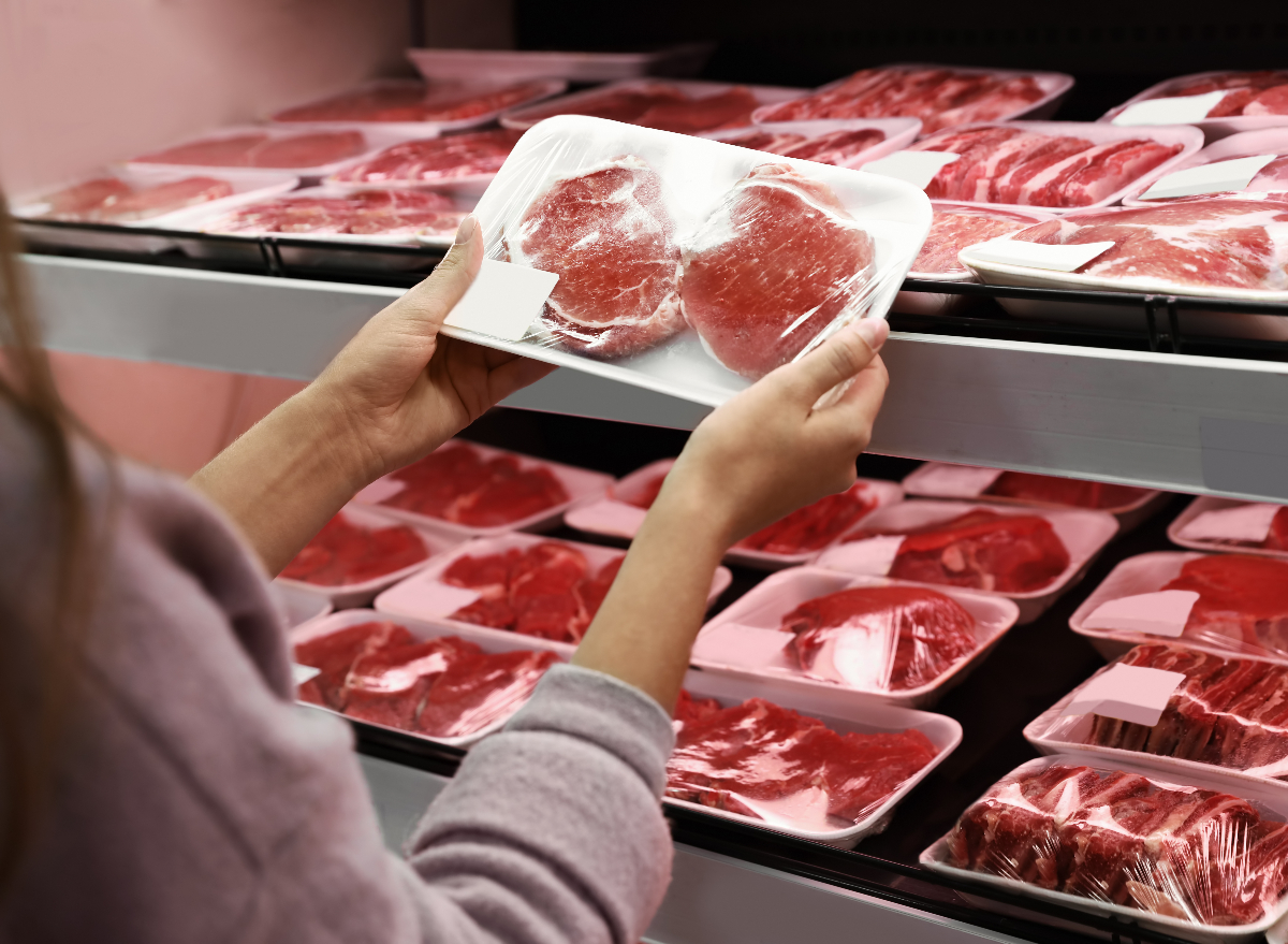 woman holding package of pork