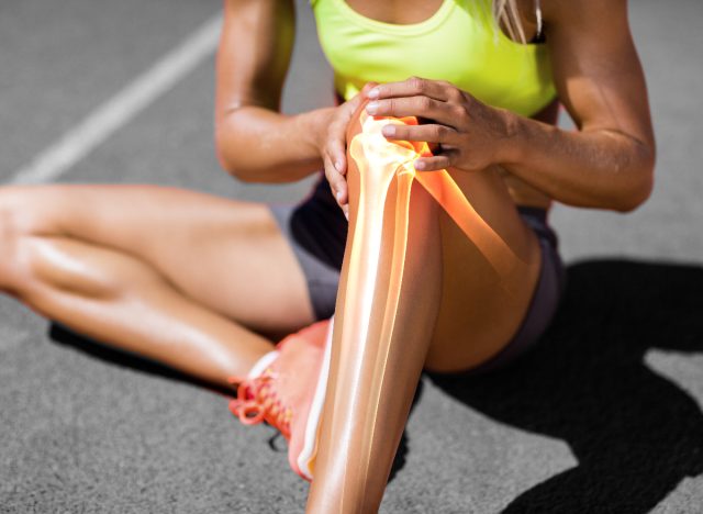 woman dealing with leg injury, pain from not warming up before workouts