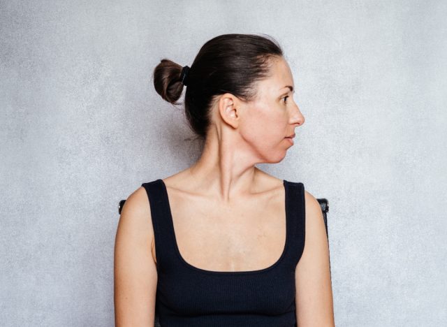 woman doing neck stretches, exercises in chair