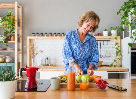 woman preparing healthy meal in bright kitchen, concept of feeling flabby at 50