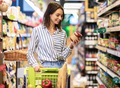 Woman With Shopping Cart In Supermarket