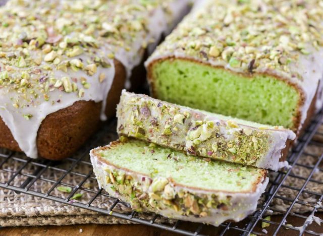 pistachio bread with icing on a cooling rack