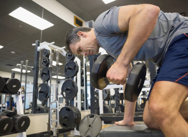 middle-aged man doing dumbbell bent-over row exercise