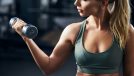 woman holding dumbbell, doing arm-strengthening exercises for women at the gym