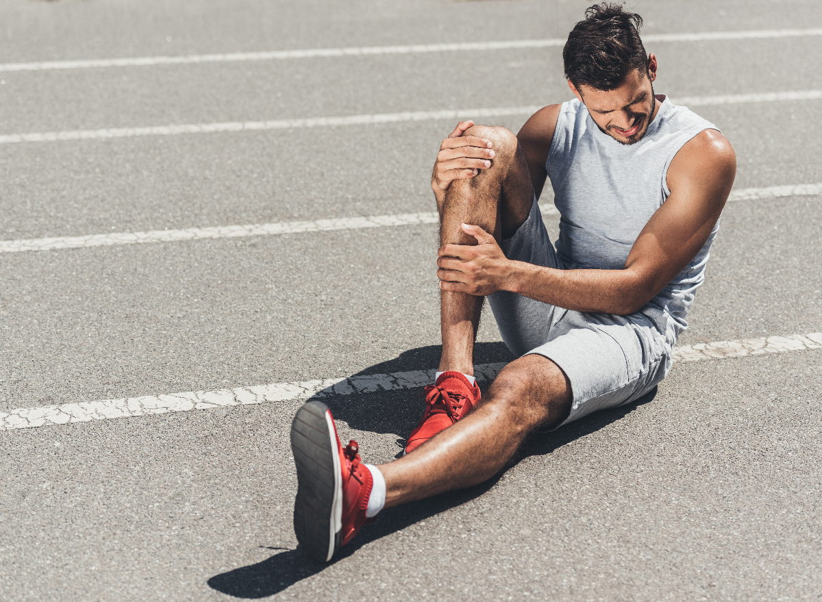 fit man dealing with leg injury on the track, concept of exercises habits that destroy your leg strength