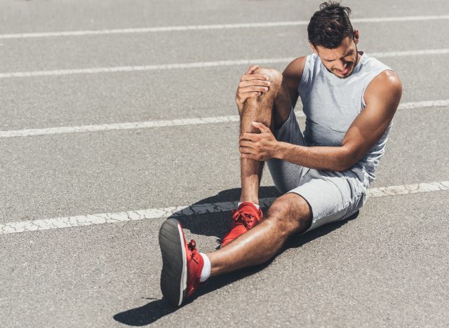 fit man dealing with leg injury on the track, concept of exercises habits that destroy your leg strength