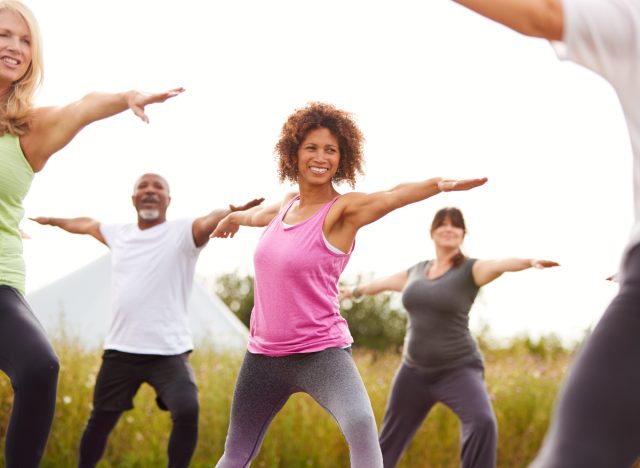 5 Fitness Habits To Build Stamina & Endurance as You Age - fitness group doing yoga outdoors