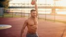 fit man holding kettlebell overhead during outdoor workout, concept of habits that kill workout progress