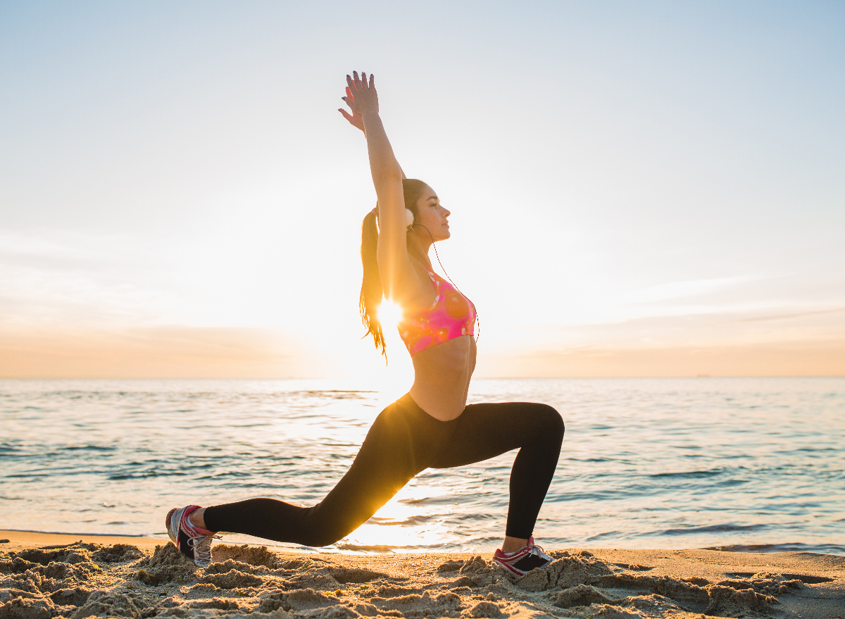 fitness woman doing beach exercises, concept of how much activity to be healthy