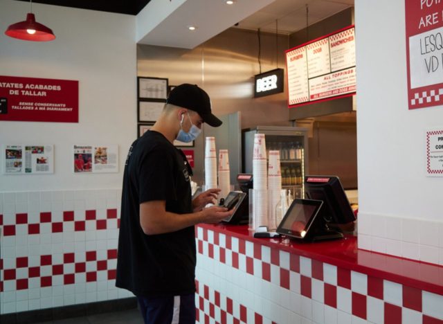 five guys paying at register