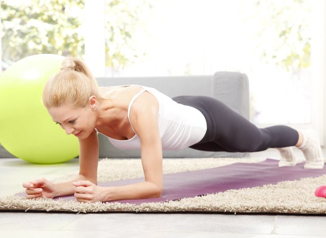 middle-aged woman doing forearm planks