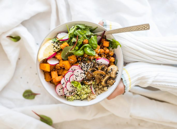 woman holding healthy buddha bowl, concept of healthy carbs for weight loss