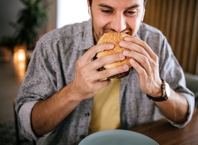 man eating burger