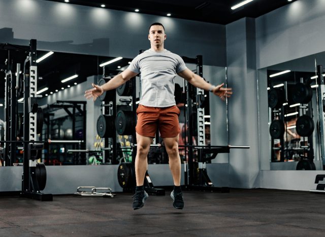 man doing jumping jacks at the gym