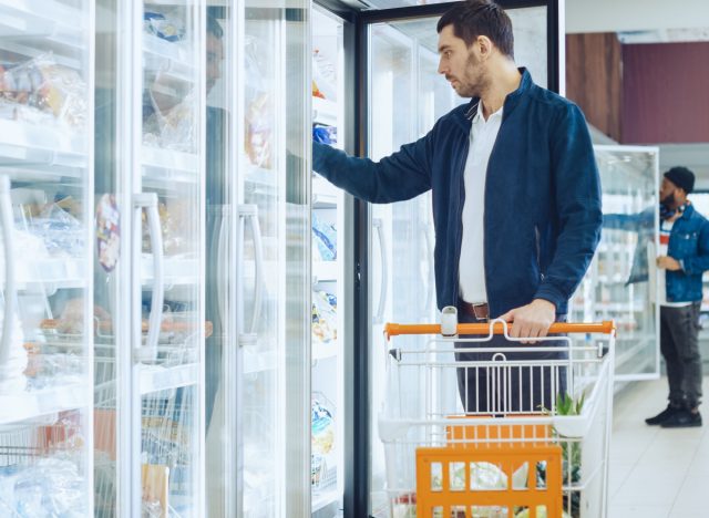 man shopping for frozen foods at the grocery store