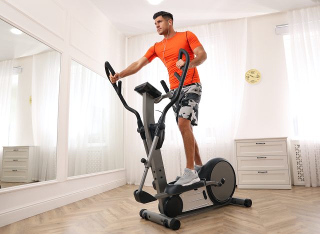 man working out on the elliptical in his home gym